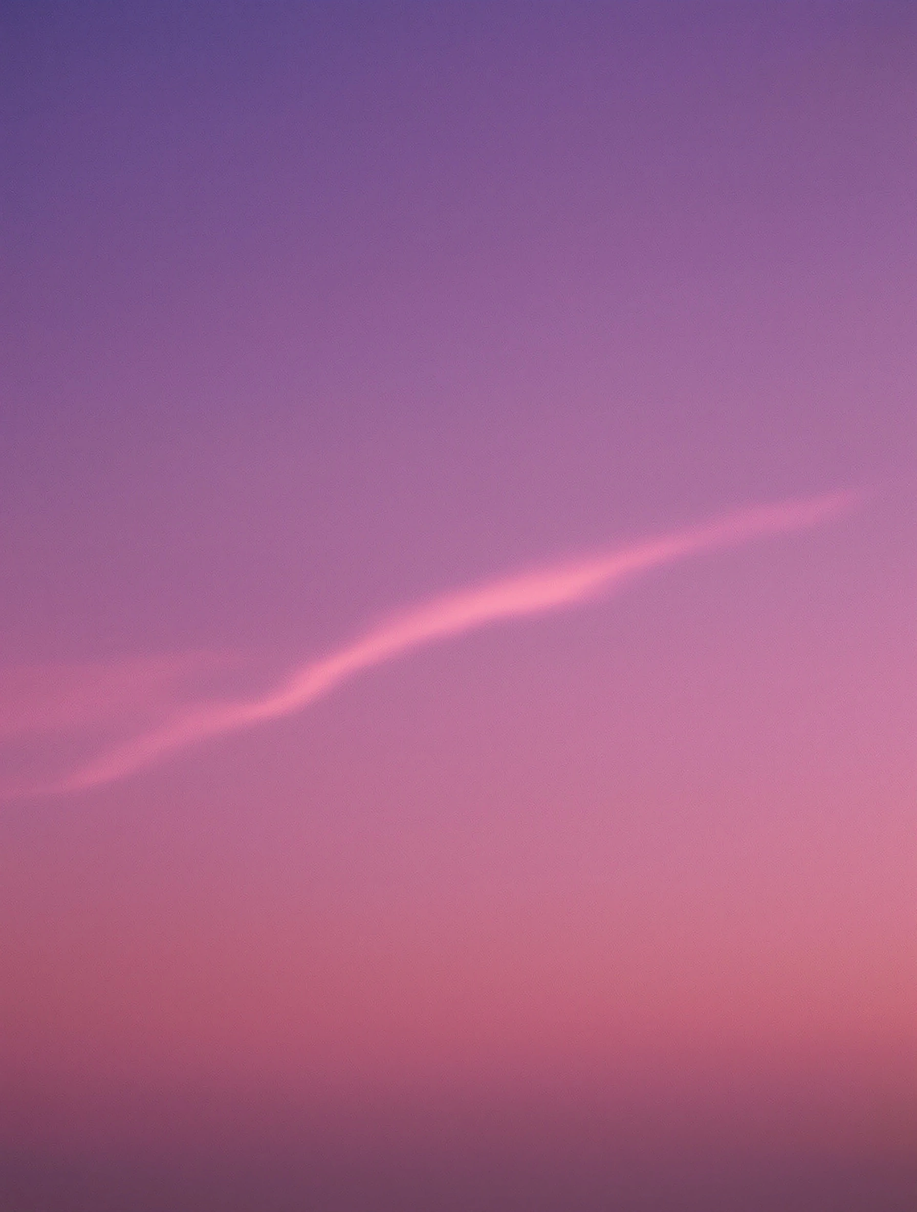 Pure dawn sky gradient running aubergine at the top through magenta to a warm coral horizon, a single slender pink contrail curling across the middle of the frame. No land, no detail, just the soft grain of early light, vertical medium-format meditation in violet and rose.