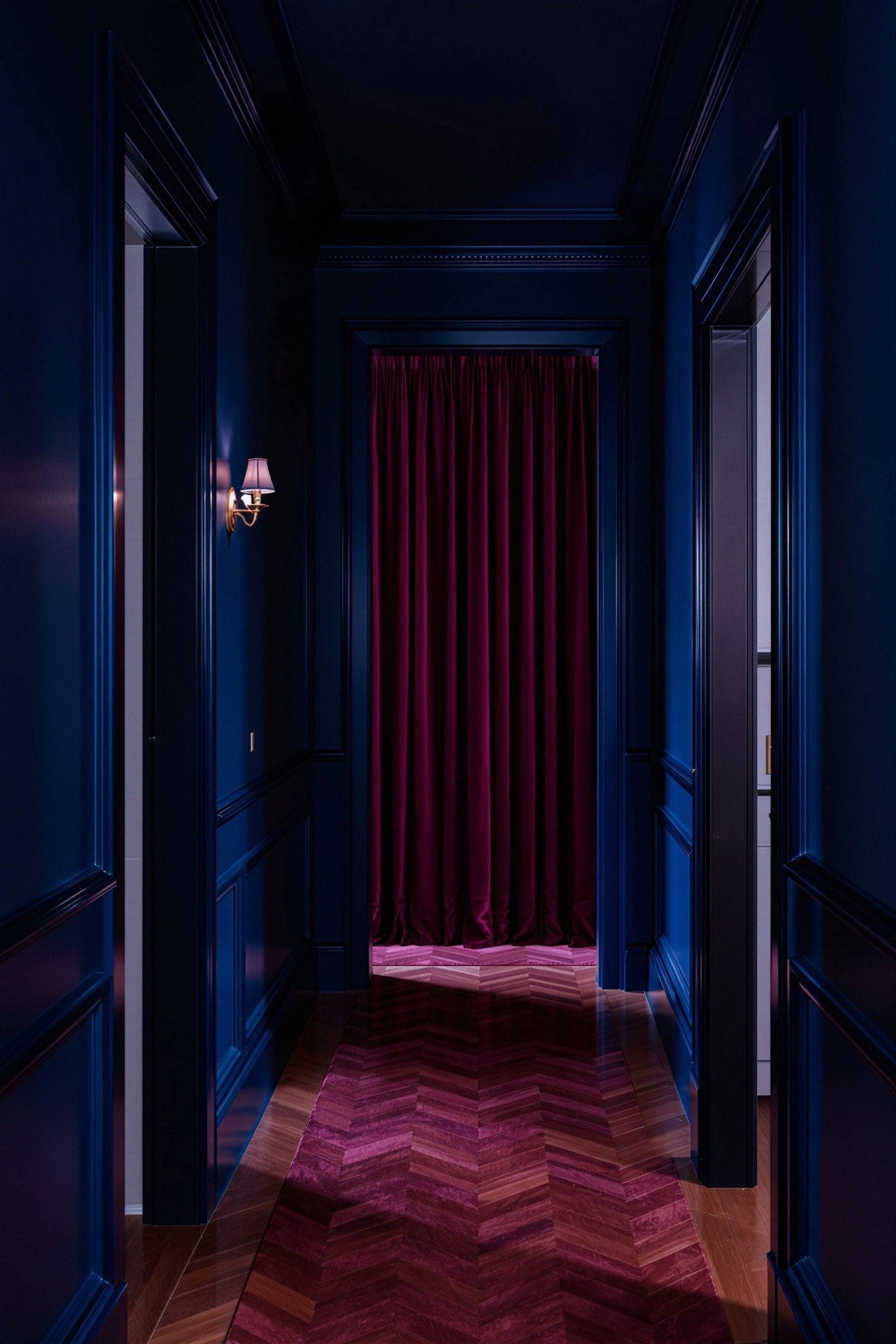 Lacquered cobalt corridor stretching toward a magenta velvet curtain at the vanishing point, chevron parquet glowing fuchsia from a single brass sconce. Polished moulding catches highlights along the walls, the air dense and theatrical, 35mm anamorphic mood with deep saturated blues and operatic crimson.