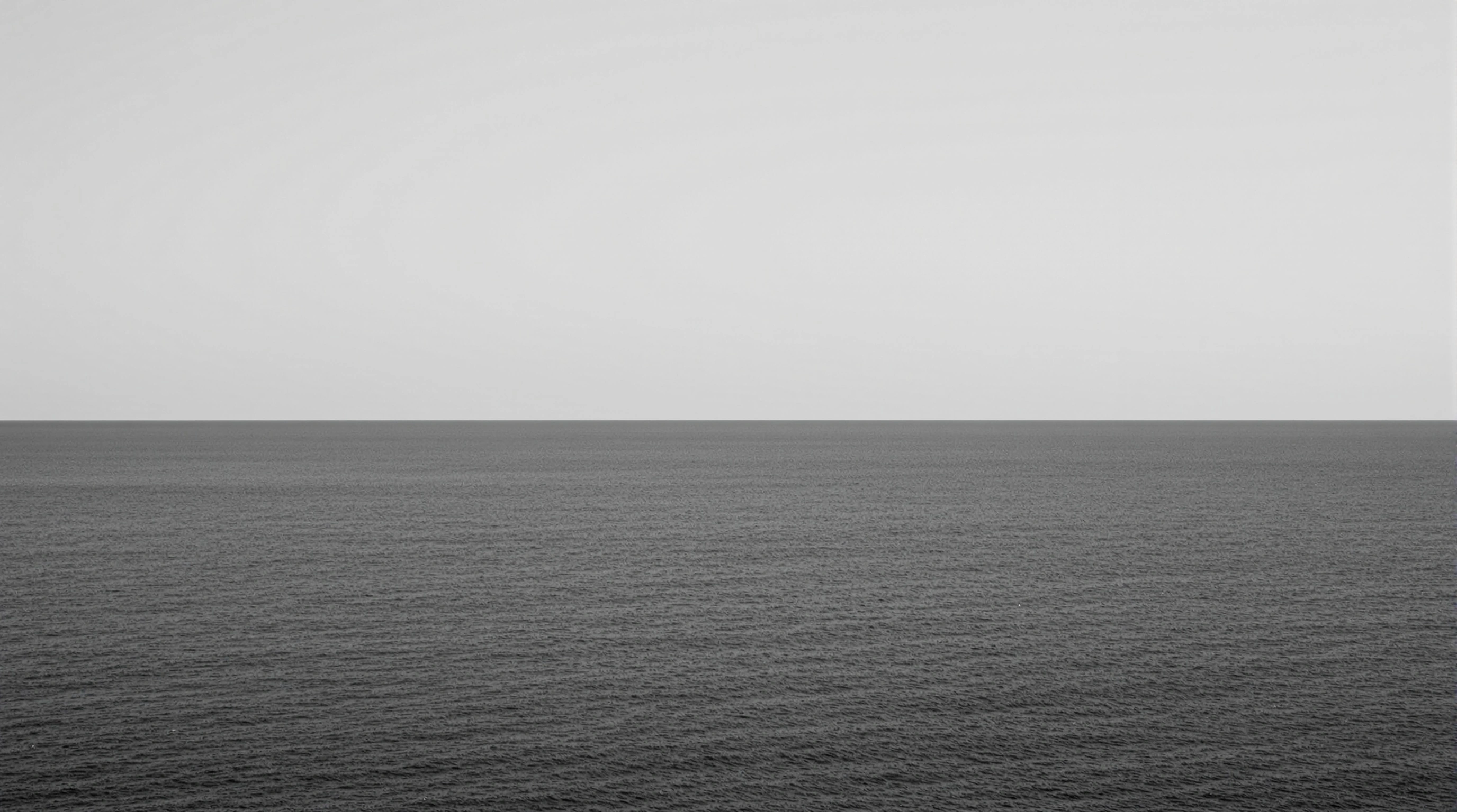 A perfectly bisected seascape: textured pewter ocean meets a milky bone-white sky at a knife-clean horizon, no land or vessel in view. Subtle gradient from steel to ash. 50mm flatness, Hiroshi Sugimoto stillness, near-monochrome study in atmospheric breath and infinite calm.