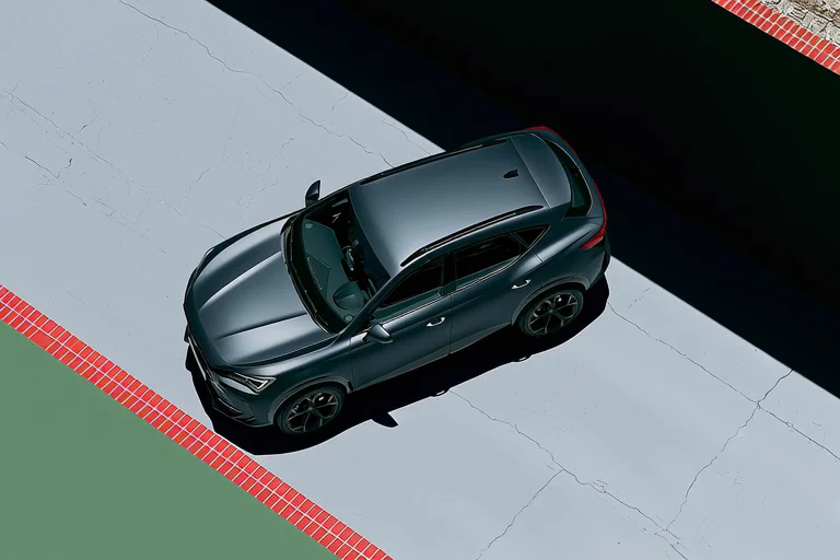 Top-down product shot of a matte dark-grey Cupra Formentor VZ5 SUV parked on a cracked concrete pad bordered by red brick edges and a green patch. Clean overhead symmetry, automotive ad styling. Motion: very slow drone descent, faint shadow shift, wheel reflections shimmer.